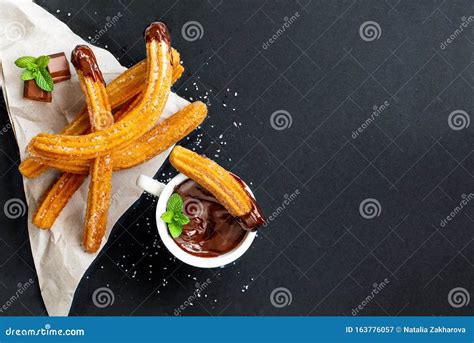 Churros With Sugar Powder With Chocolate Sauce Dip And Spearmint Leaf