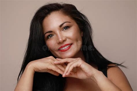 Mature Hispanic Woman With Red Lips Posing And Smiling Over White