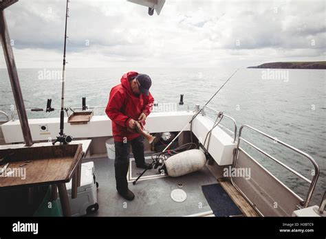 Fisherman catching a fish Stock Photo - Alamy