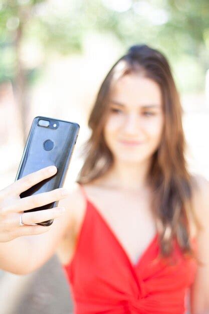 Premium Photo Close Up Of Smiling Woman Taking Selfie Through Smart Phone