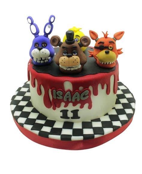 a birthday cake decorated with three different animal heads on it's top ...