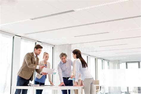 Team Of Business People Having Discussion At Table In New Office Stock