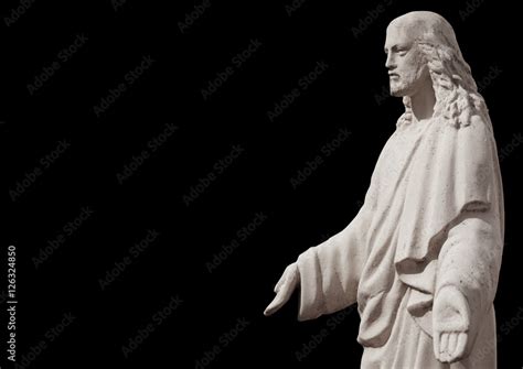 Jesus Christ statue against black background Stock Photo | Adobe Stock