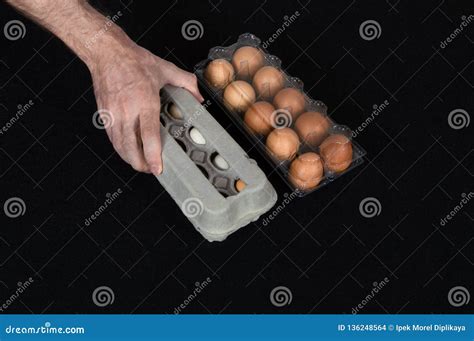 Male Hand Picking A Carton Egg Box Instead Of Plastic Box Full Of Hen