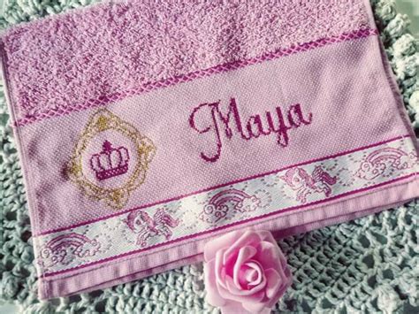 A Pink Towel With The Name Mayoa On It Next To A Pink Rose And