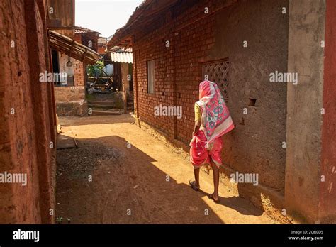 A Village Woman In Typical Maharashtra Style Saree Walks In A Lane Of A Village In Rural