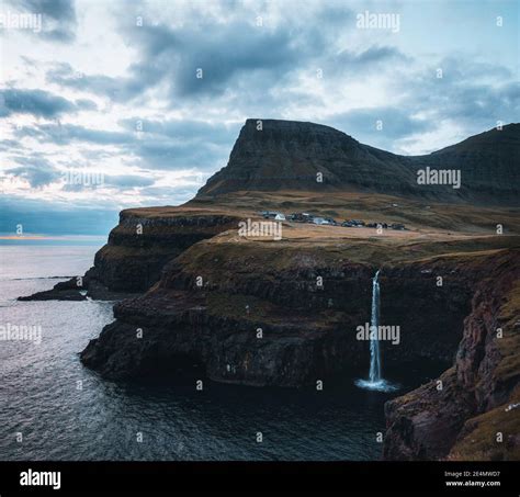 Gasadalur Village And Mulafossur Its Iconic Waterfall During Sunset In