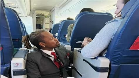 Flight Attendant Sits Down On Floor Holds Nervous Passenger S Hands To