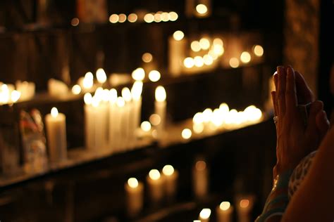 Close Up Photograph of Person Praying in Front Lined Candles · Free ...