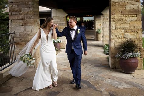 Casey kisses Darren's hand after their ceremony at Sanctuary Golf Course - Justin Edmonds ...