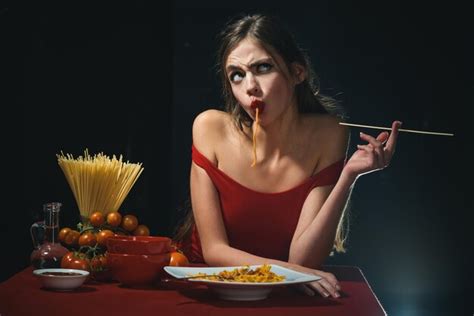 Premium Photo Sexy Woman Bites Sensually Cooked Spaghetti Sensually Twirling The Noodles