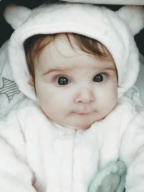 Premium Photo Portrait Of Cute Baby Lying On Bed