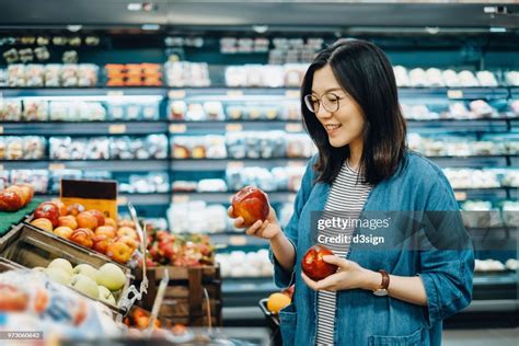 Young Asian Woman Shopping For Fresh Organic Fruits In Supermarket High