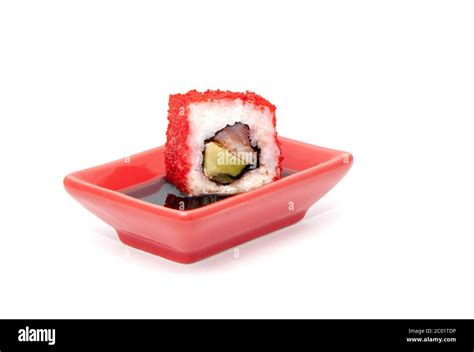 Sushi roll dipped in soy sauce Stock Photo - Alamy