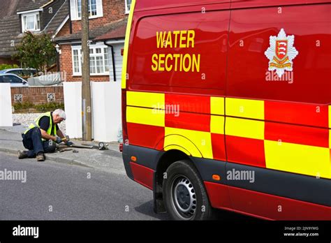 Essex Fire And Rescue Service Water Section Fire Brigade Van Driver Laying On Pavement Removing