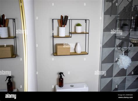 minimalist bathroom  metal wall shelf  shower caddy stock photo