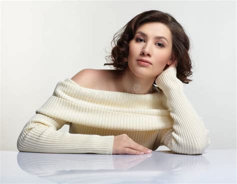 Beautiful Brunette Woman Dressed In Large White Woolen Sweater Is