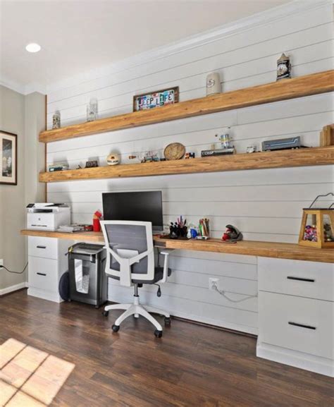 A Home Office With White Walls And Wooden Shelves On The Wall Along