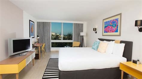 King-size bed, work desk & a TV in Island View at Warwick Paradise ...