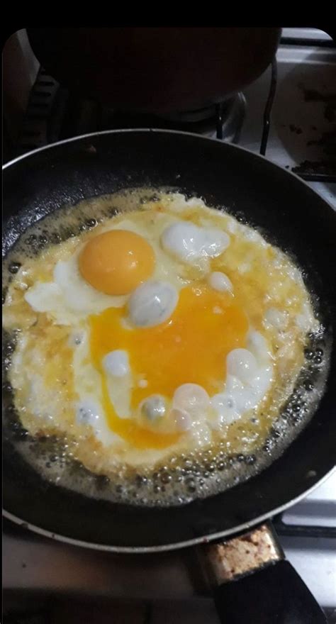 An Egg Frying In A Skillet On The Stove