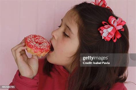 Girl With Donut Photos And Premium High Res Pictures Getty Images