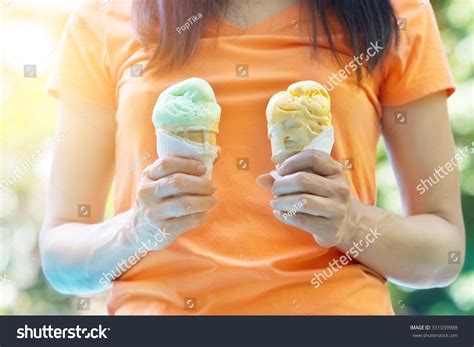 Woman Holding Melting Ice Cream Waffles Stock Photo