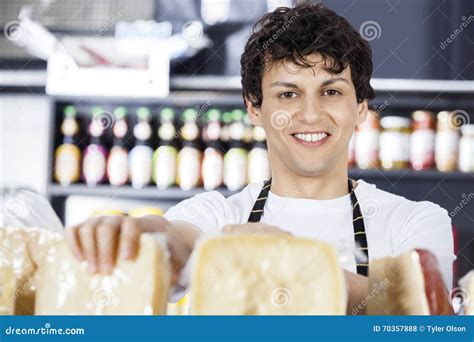 Confident Salesman Arranging Cheese In Shop Stock Photo Image Of