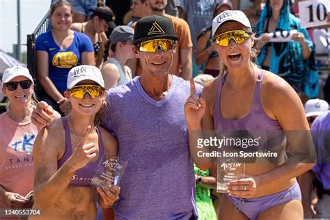 Taryn Kloth And Kristen Nuss Stand Wit Their Coach After Winning The