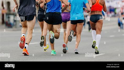 Back Legs Group Runners Run Marathon Female And Male Athletes Jogging