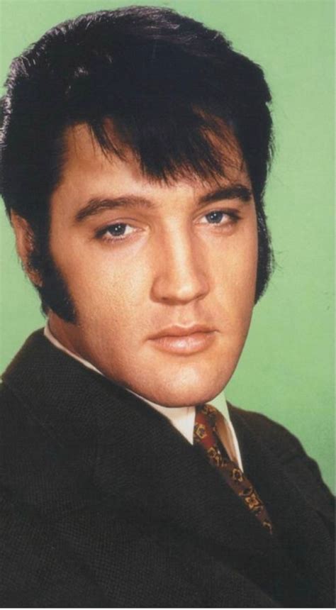 An Old Photo Of Elvis Presley Wearing A Suit And Tie With His Hair