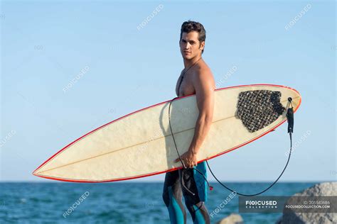 Man At The Beach With Surfboard By Brandon Tabiolo Printscapes