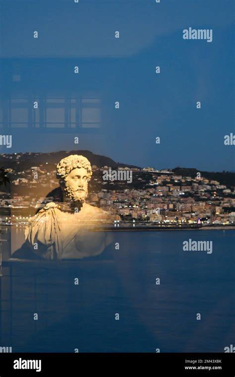 An ancient Roman statue reflected on a glass in the museum of Roman history in Bacoli, italian ...