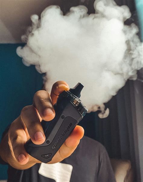 Person Holding Black Vape · Free Stock Photo