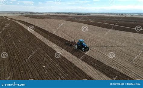 Tractor harrowing field stock footage. Video of agricultural - 253978496