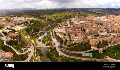 Aerial View Of Toledo Cityscape On Tagus River With Alcazar Castle