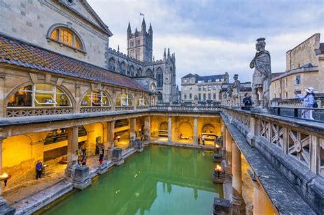 The Roman Baths And Bath Abbey Illuminated At Dusk Unesco World