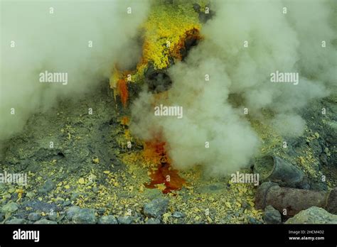 Molten sulfur dripping from pipes at Kawah Ijen volcano, East Java ...