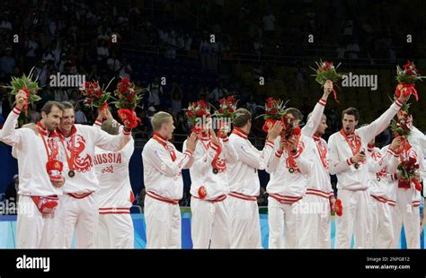 Russia S Players With Their Bronze Medals Wave Bouquets Of Flowers