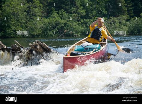 Man Shooting Rapids In Red Canoe Stock Photo Alamy