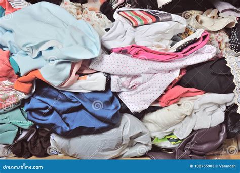 Pile Of Messy Clothes In Closet. Untidy Cluttered Woman. Royalty-Free ...