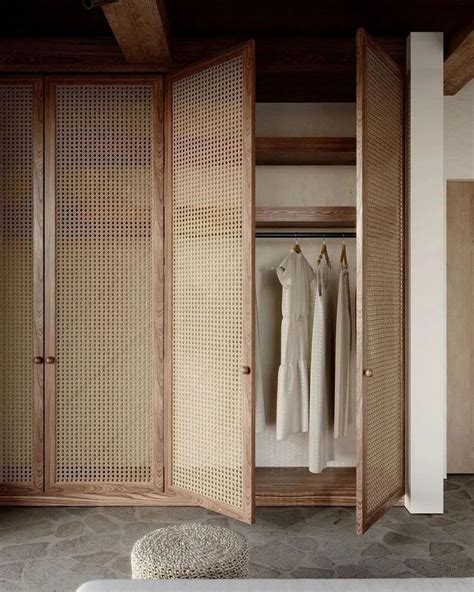 An Open Closet With Clothes Hanging In It