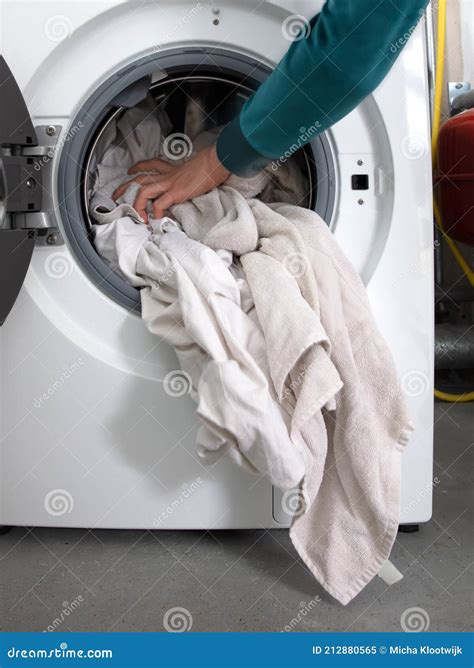 Man Filling Laundry In The Washing Machine Royalty Free Stock Photo