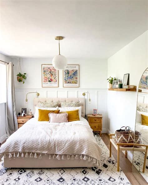 A Bedroom With White Walls And Yellow Accents