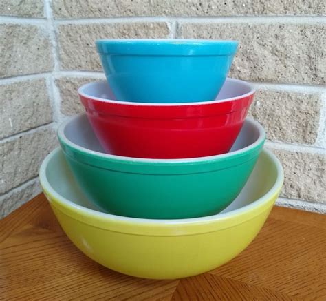 Three Bowls Stacked On Top Of Each Other In Front Of A Brick Wall And