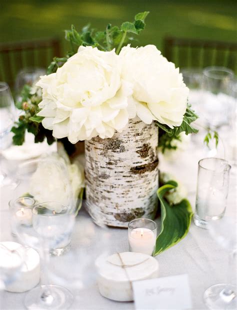 White Flower Centerpiece With Birch Tree Wrapped Around Rustic Wedding