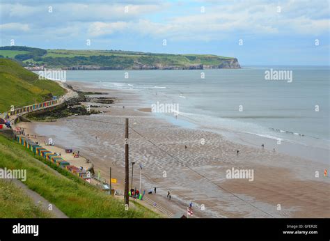 Multi-coloured beach huts at Whitby Beach, Whitby, Yorkshire, England, UK. Sandsend in the ...