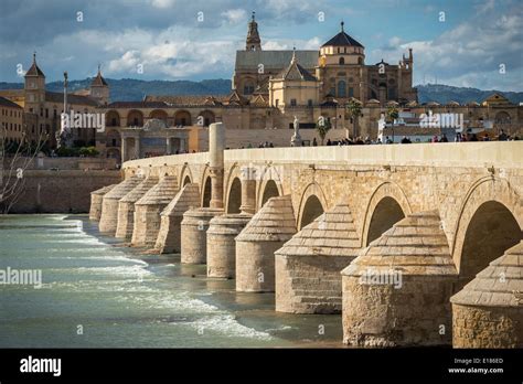 Looking across the Guadalquivir river and Roman bridge to the cathedral ...