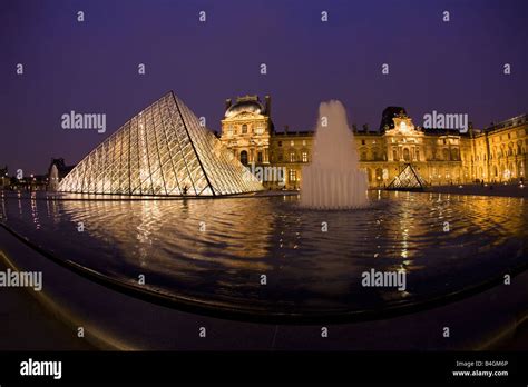 Glass Pyramide At Entrance To Le Louvre Museum And Art Gallery At Night