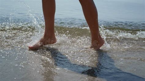 Tanned Woman Legs Splashing Ocean Waves On Sunlight Close Up Girl Feet