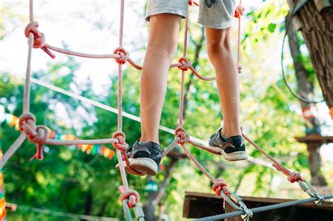 Niño Pasa El Obstáculo En El Parque De Cuerdas Foto Premium